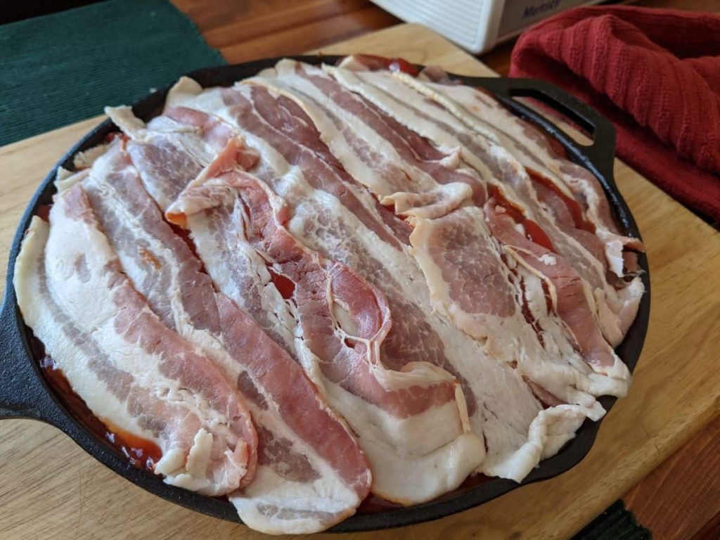 uncooked meatloaf in a cast iron pan