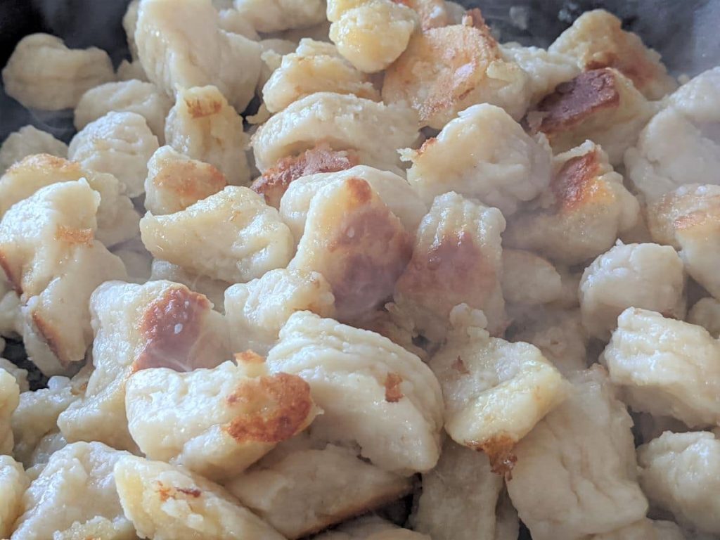 handmade gnocchi frying in a pan