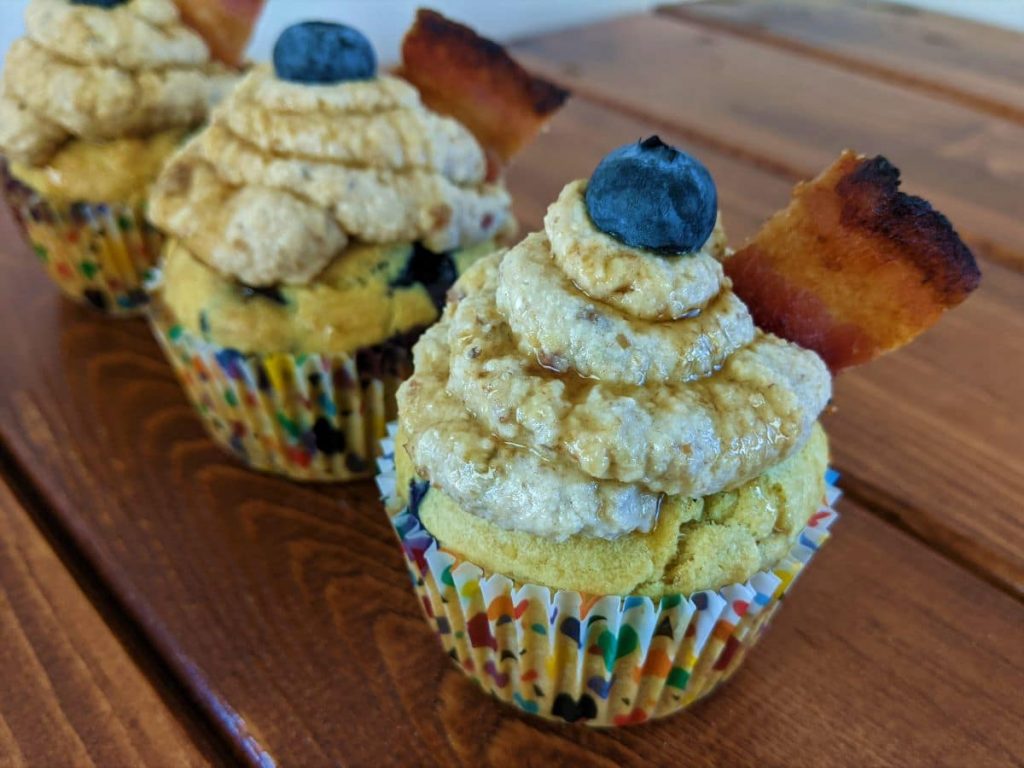 blueberry pancake cupcakes lined up in a row on a table