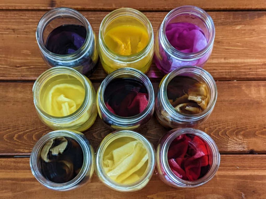 natural dye and cloth in mason jars on a table