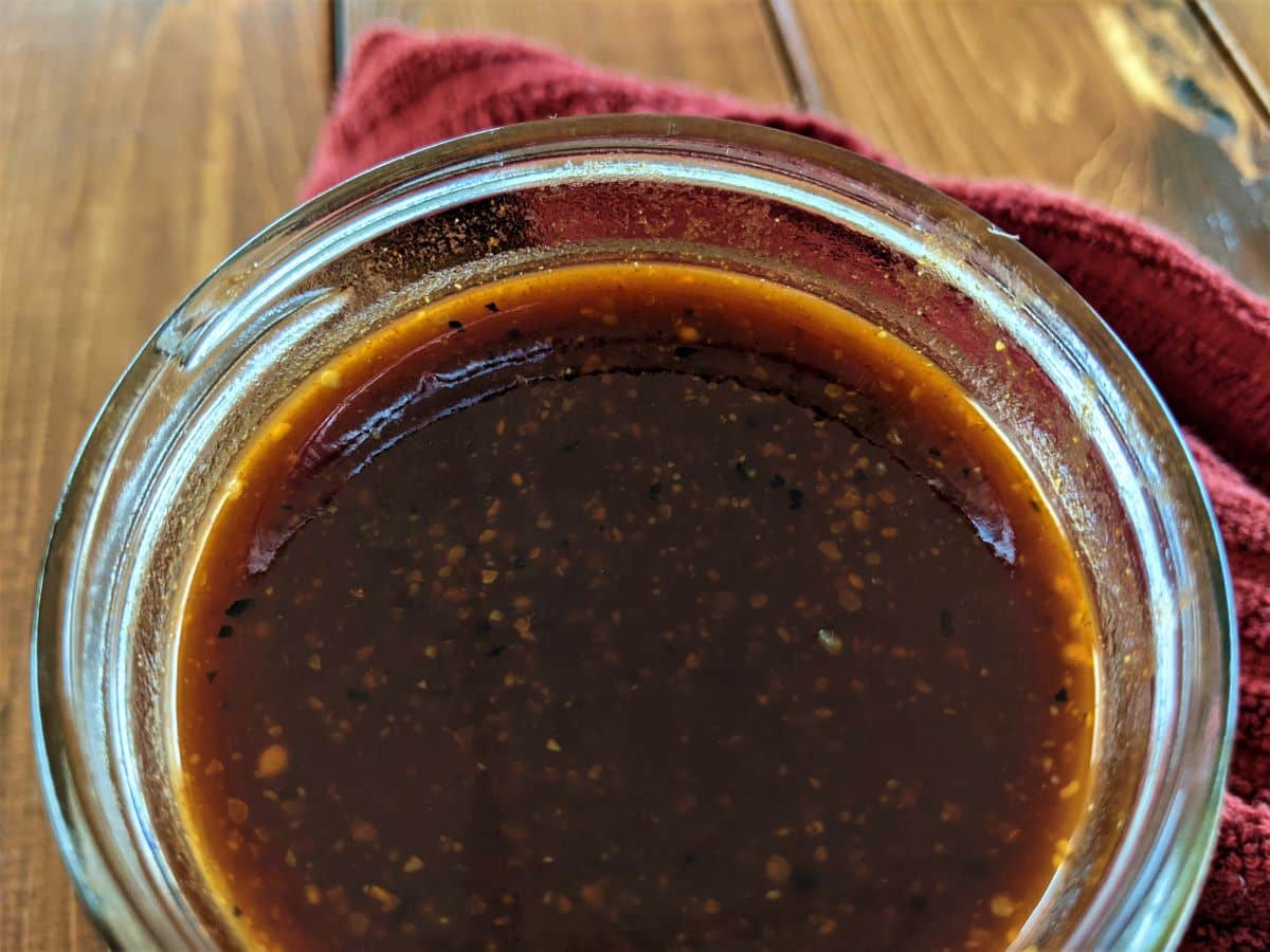 handmade bbq sauce in a mason jar on a table.