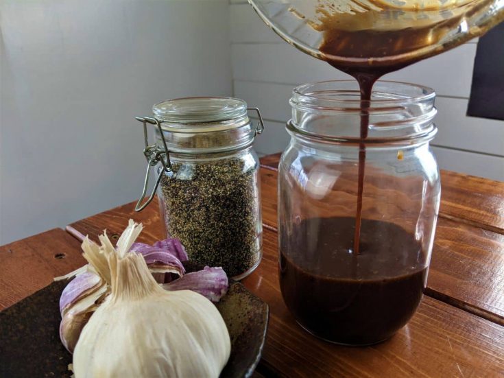 pouring homemade dressing into a jar
