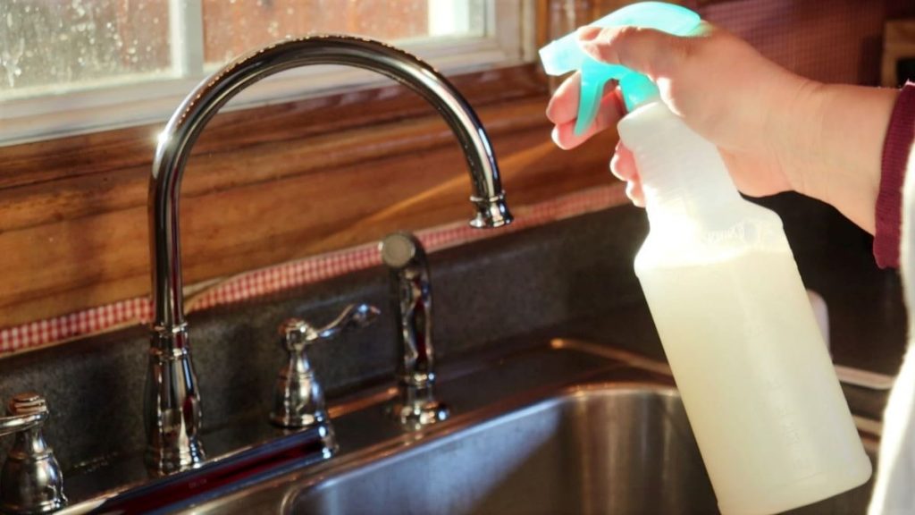 spraying faucet with diy natural cleaning spray