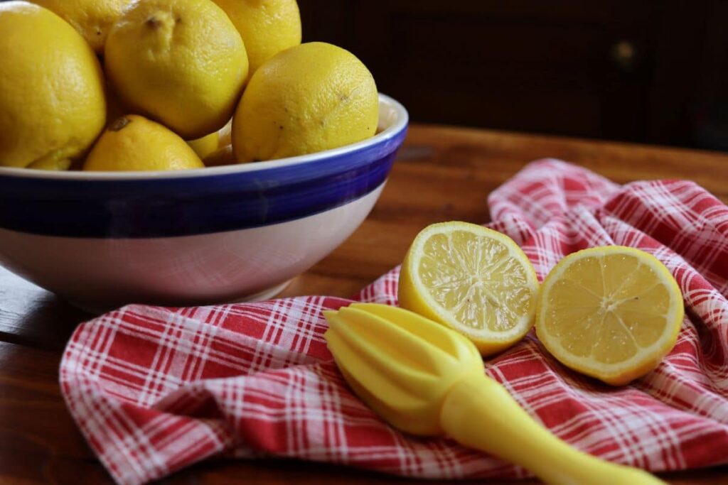 bowl of lemons with juicer