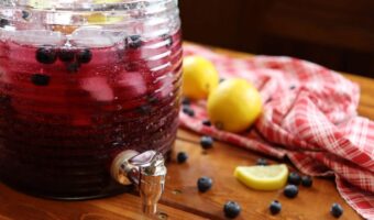 homemade sparkling blueberry lemonade being served in a picture