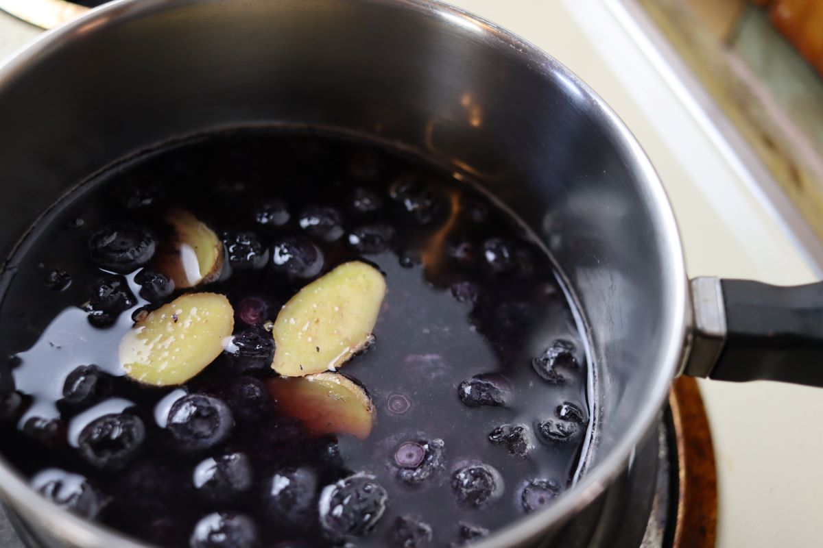 blueberries and ginger simmering in a pot