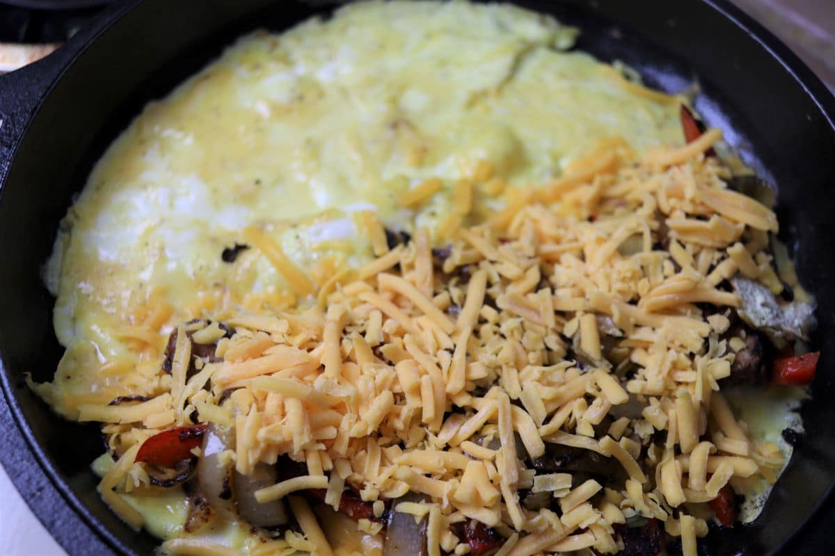 omelet cooking in a cast iron skillet