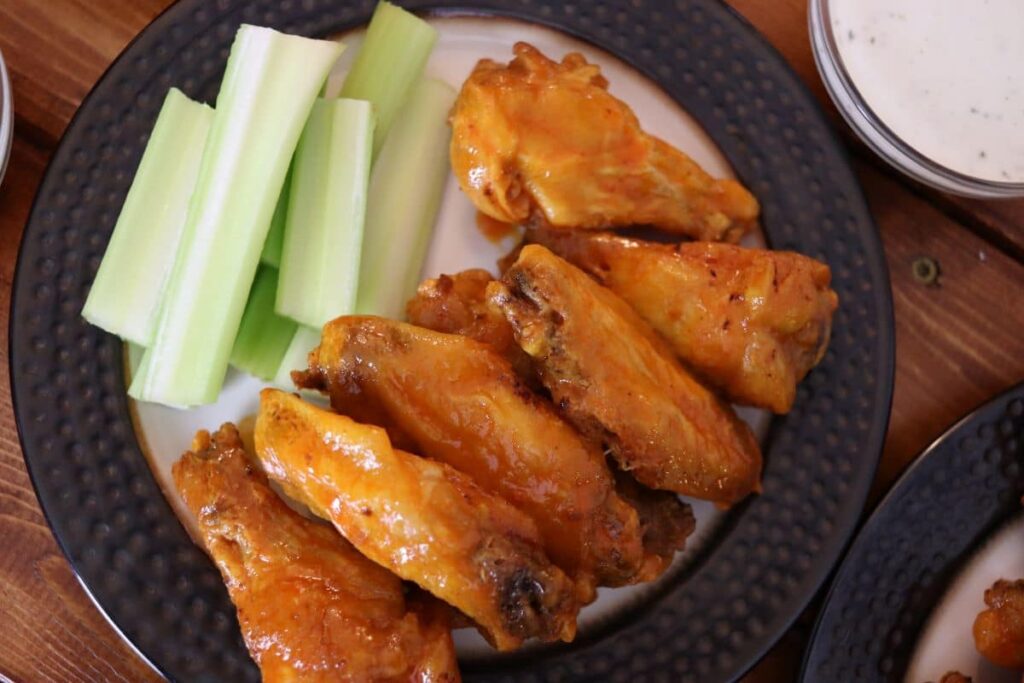 buffalo chicken wings on a plate with celery