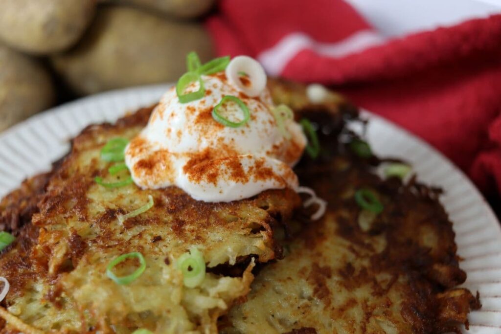 authentic german potato pancakes topped with sour cream and scallions