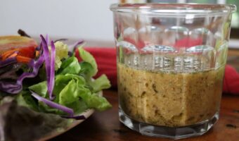 handmade tangy mustard salad dressing in a glass on a table