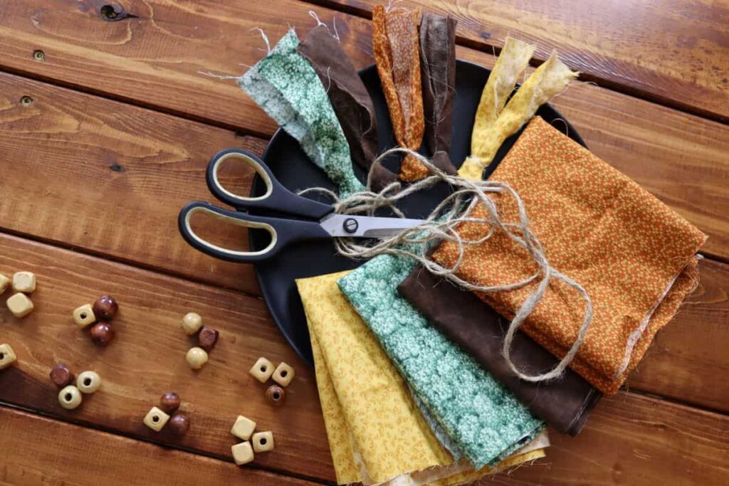 supplies to make fall rag tie garland on a table