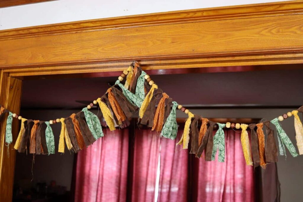 fall rag tie garland hanging in a doorway