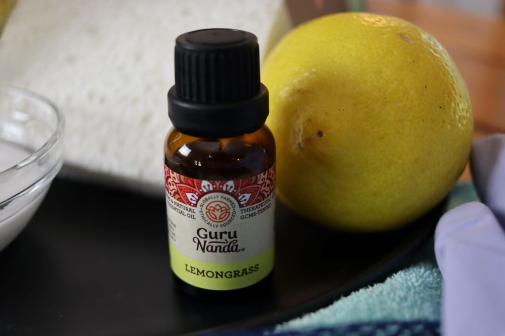 lemongrass essential oil on a plate with a lemon and a sponge