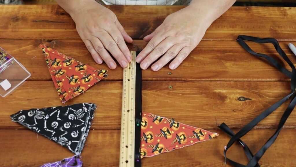 placing a flag in binding for a diy halloween flag banner