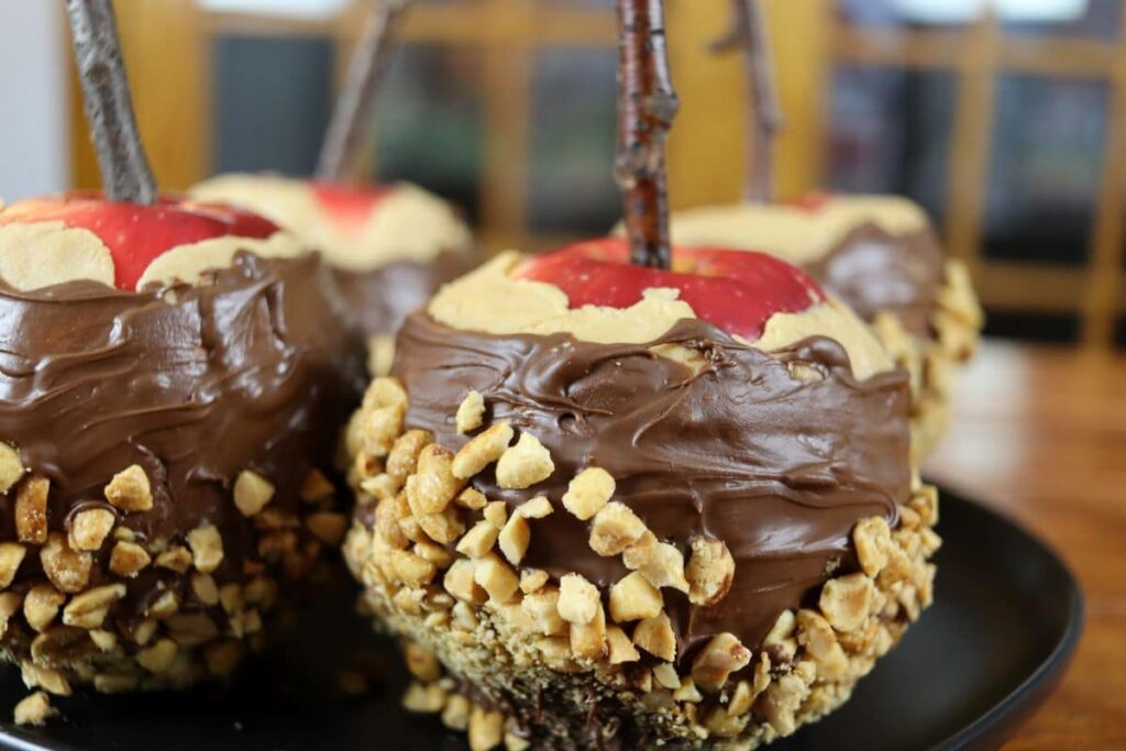 handmade peanut butter candy apple displayed on a dish