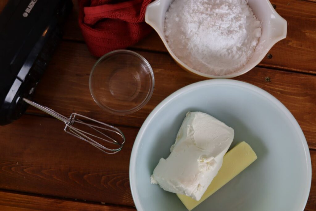 ingredients for cream cheese frosting with an electric mixer