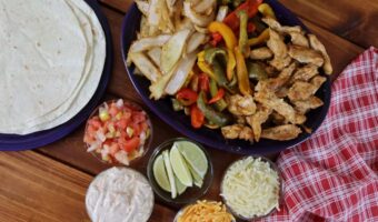 tex mex chicken sheet pan dinner with toppings laid out on a table