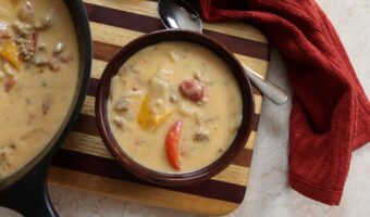 bowl of homemade creamy sausage and pepper soup with a spoon