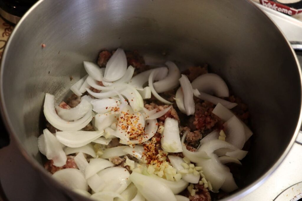 sausage, onion, and spices in a pot