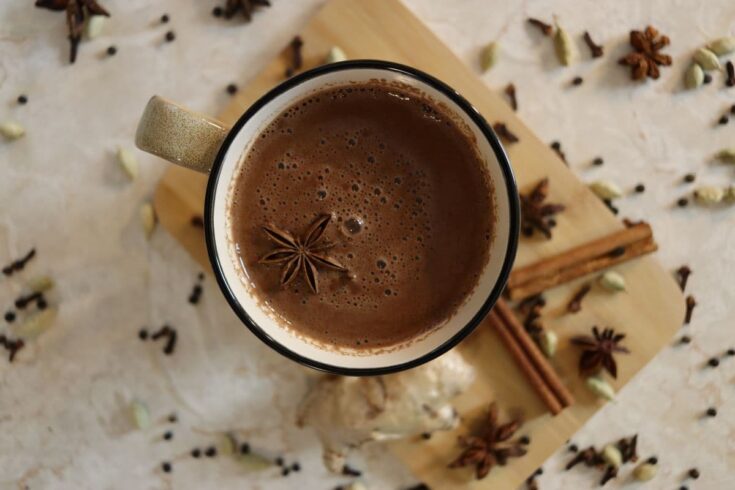 an overhead view of a cup of freshly made chai spiced cacao