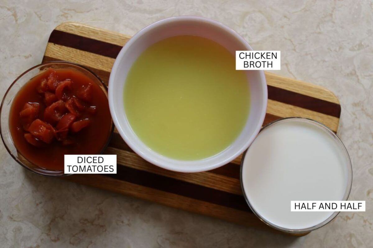 Ingredients for creamy sausage and pepper soup labeled diced tomatoes, chicken broth, and half-and-half.