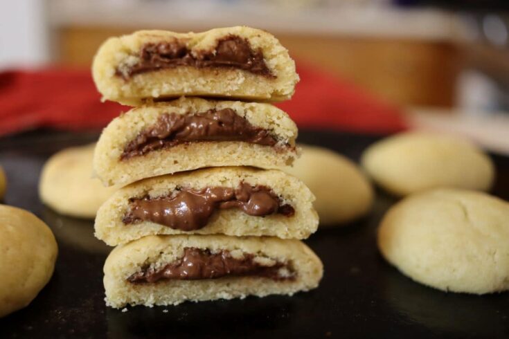 homemade nutella cookies cut and stacked on a counter
