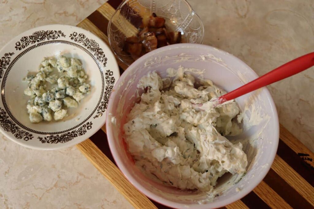 ingredients for bacon blue cheese dip mixed in a bowl