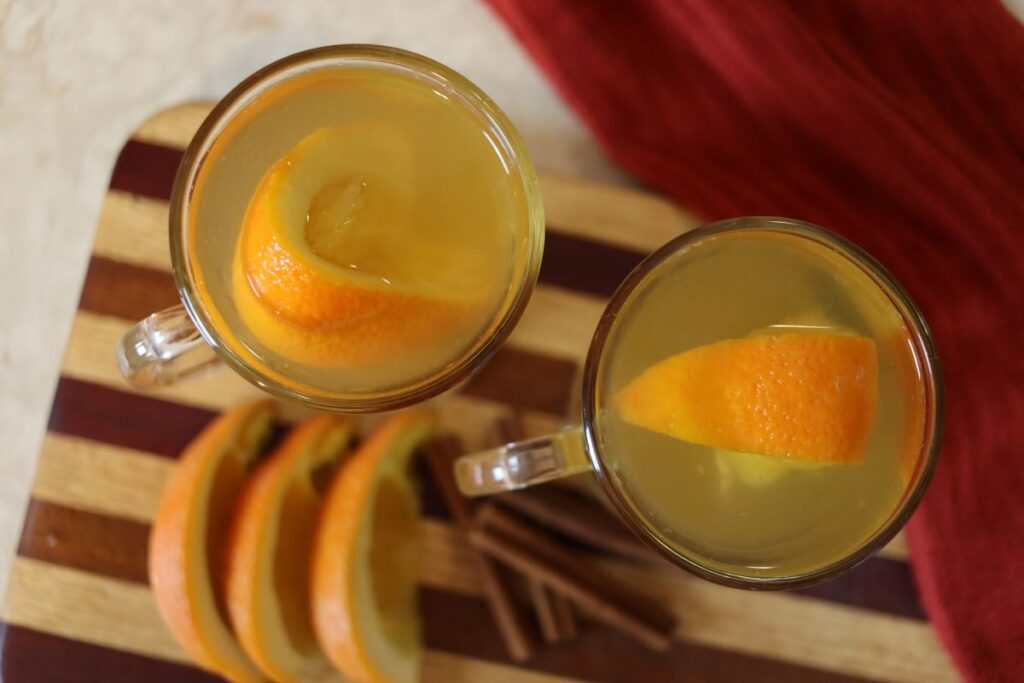 overview of homemade hot beverages with orange slices