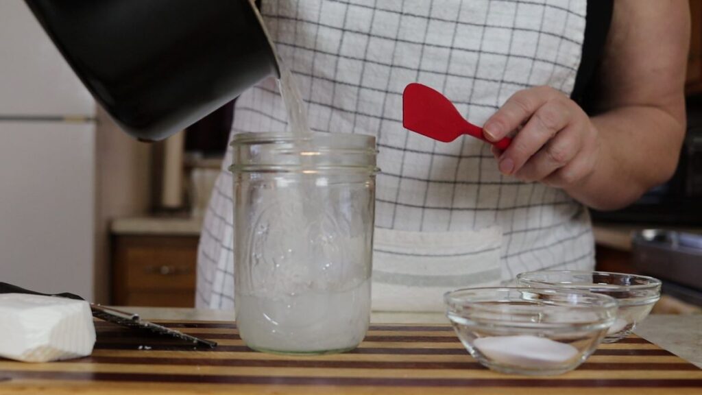 pouring diy cleaning solution into a jar