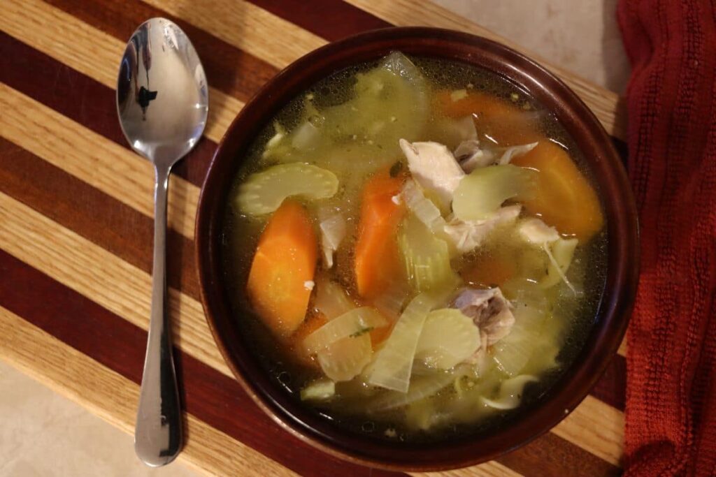 hot bowl of homemade chicken soup on a table