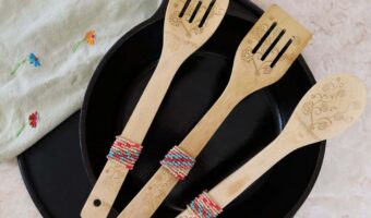 diy beaded wooden spoons displayed on a counter