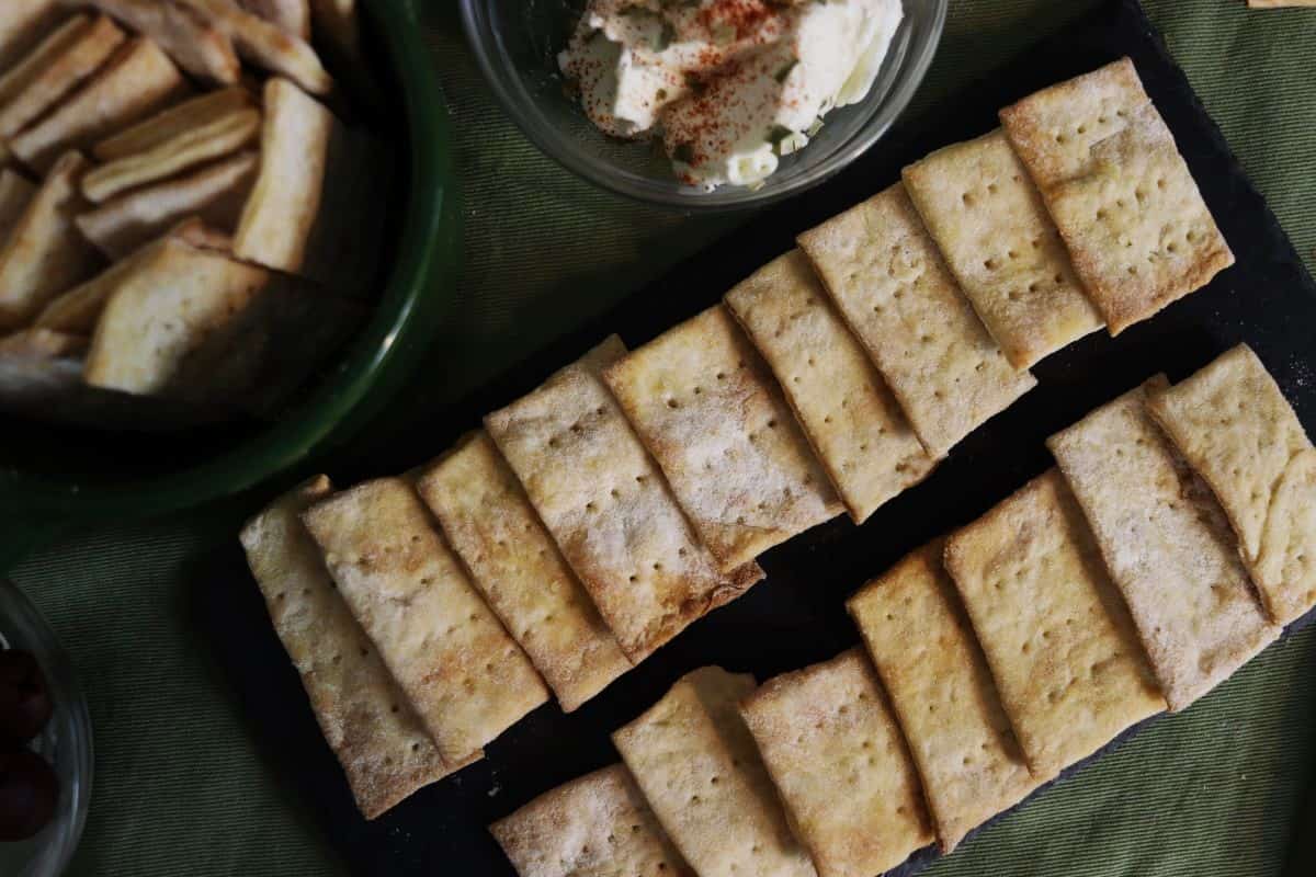 homemade crackers displayed on a slate board