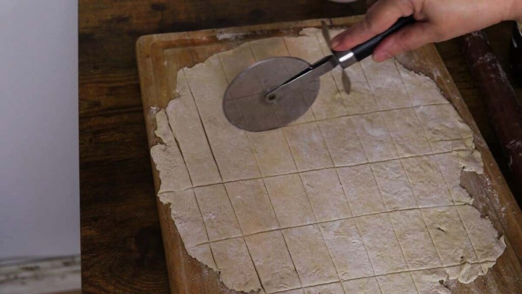 cutting rolled out dough into squares