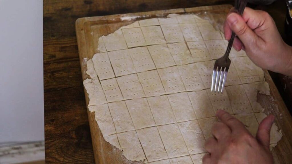 poking holes in rolled out dough with a fork