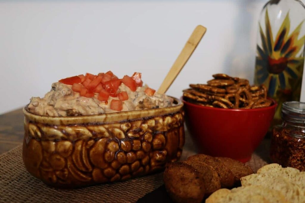 freshly made sausage dip in a serving dish with a spoon