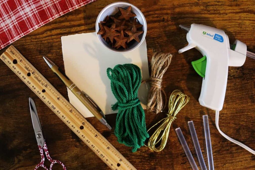 supplies to make a diy tree shaped ornament on a table