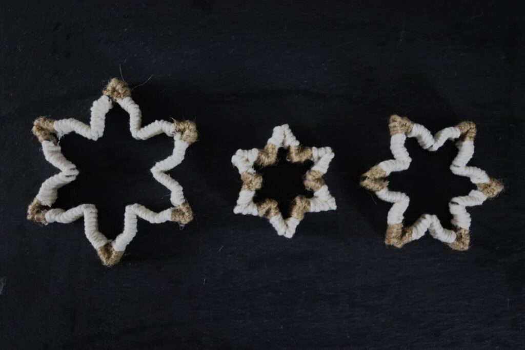 3 twine cookie cutter ornaments on a slate board