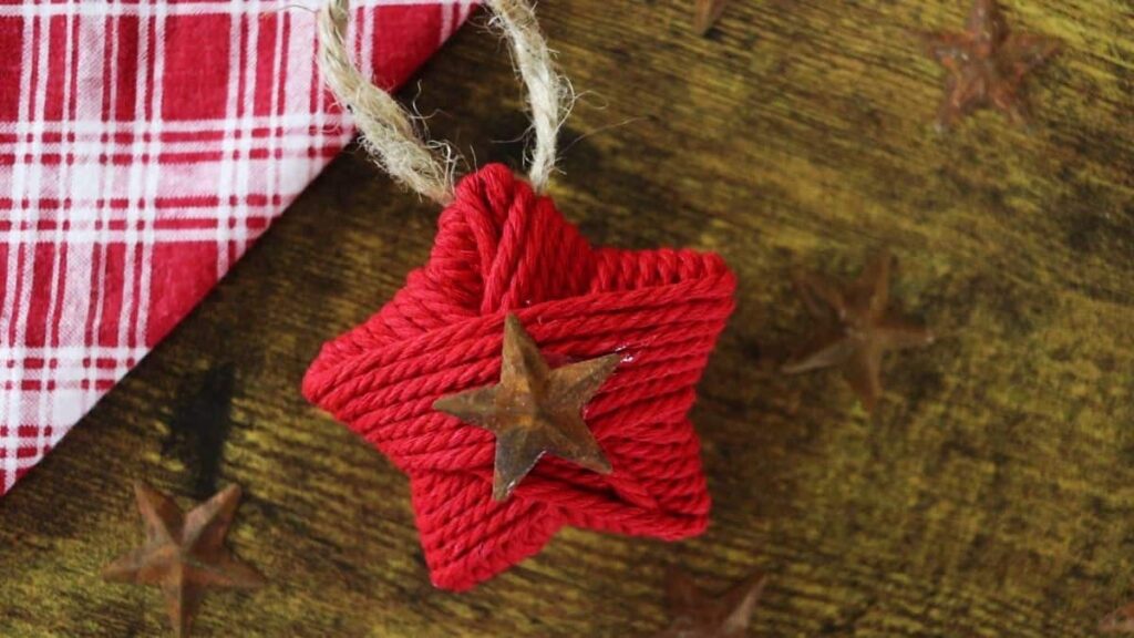 red twine wrapped star ornament on a table