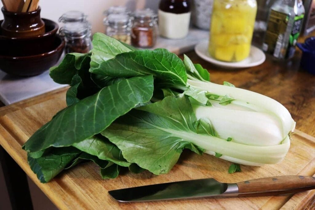 garden fresh bok choy laying on a cutting board