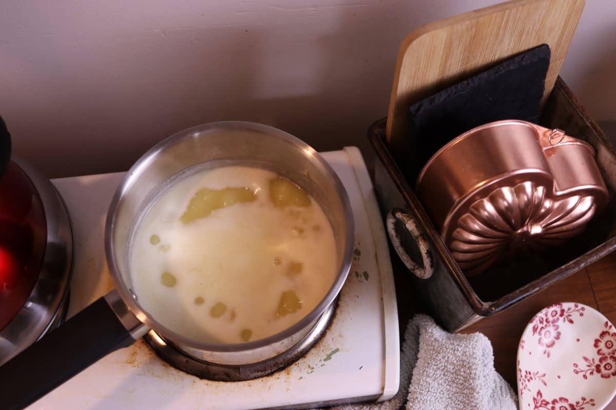 lemon syrup simmering in a saucepan on a stovetop.