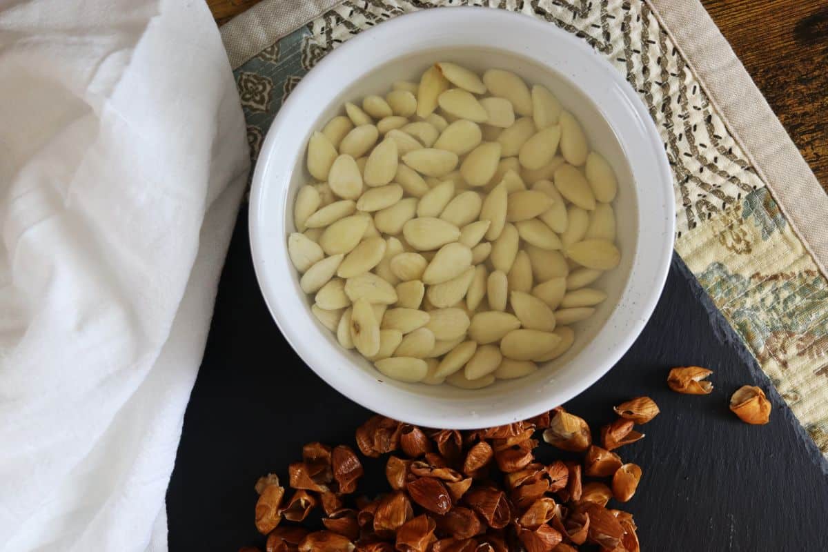 peeled almonds soaking in a bowl of water.