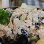 a scoop of gluten free chicken salad with grapes and parsley.