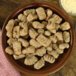 Bowl of handmade brown gnocchi dumplings.