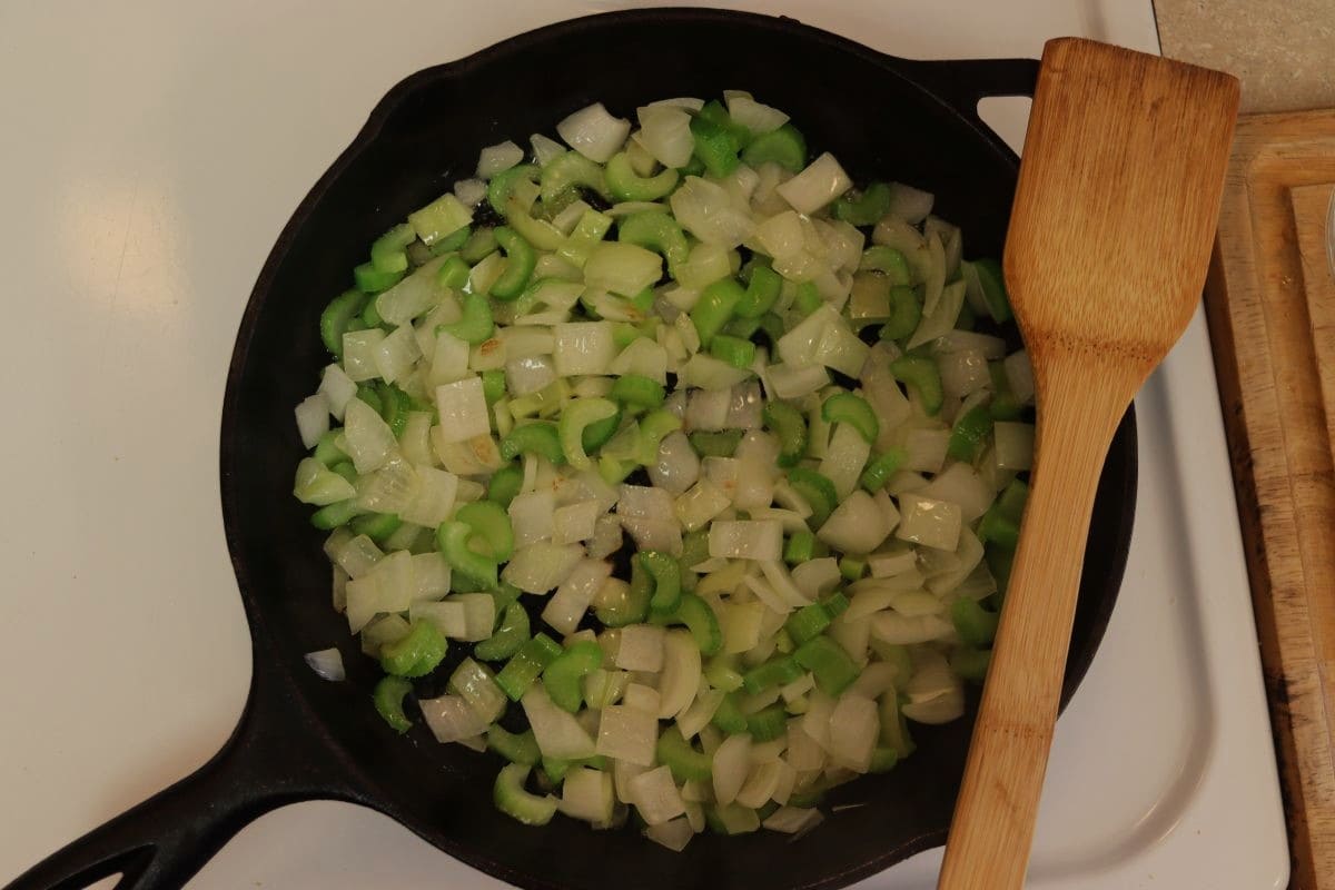 Celery and onions in a cast iron skillet.