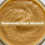 Homemade Dijon mustard in a glass bowl with “Homemade Dijon Mustard” text overlay.