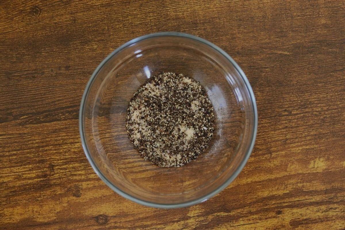 Salt, pepper, and granulated garlic mixed in a small glass bowl.