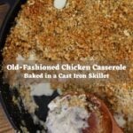 Vertical image of a cast iron skillet with a browned breadcrumb topping and a wooden spoon scooping a pale mixture, with text overlay reading “Old-Fashioned Chicken Casserole Baked in a Cast Iron Skillet".