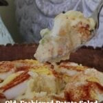 Spoon lifting old-fashioned potato salad with sliced eggs and paprika from wooden bowl. Text reads “Old-Fashioned Potato Salad The Creamy Classic That Never Fails".