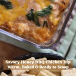 Savory honey BBQ chicken dip in glass dish with crackers and text overlay reading “Savory Honey BBQ Chicken Dip Warm, Baked & Ready to Scoop".