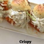 Crispy buffalo chicken sliders with lettuce and dressing on poppy seed buns, text reads Crispy Buffalo Chicken Sliders.